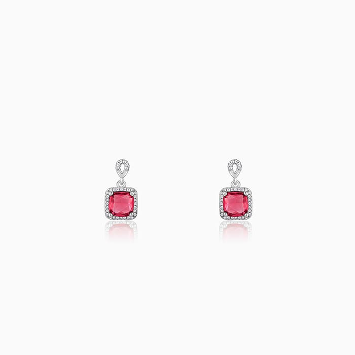 Silver earrings with pink stone and zircon accents in a square design.
