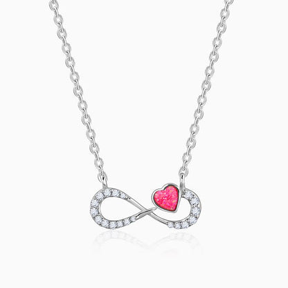 Silver infinity necklace with pink opal heart and zircon accents
