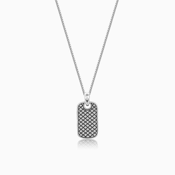 Silver pendant with grid pattern and box chain, symbolizing boldness and confidence.

