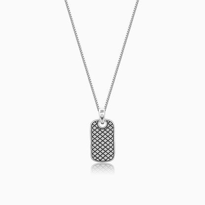 Silver pendant with grid pattern and box chain, symbolizing boldness and confidence.

