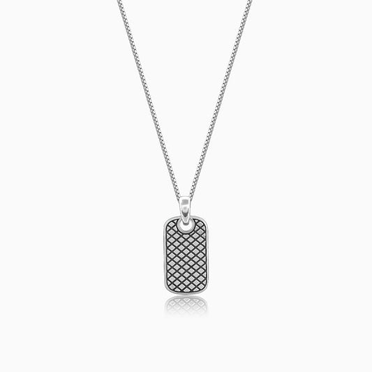 Silver pendant with grid pattern and box chain, symbolizing boldness and confidence.

