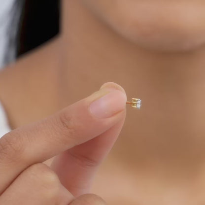 Gold stud earrings with a lab grown diamond.